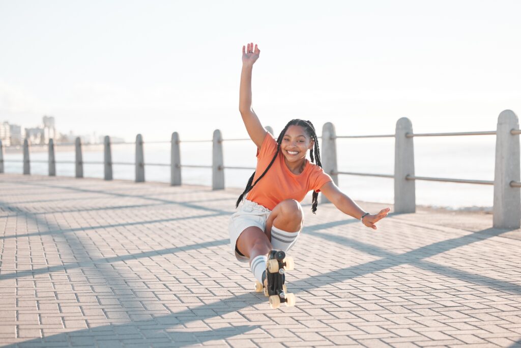 teen girl skating on boardwalk
